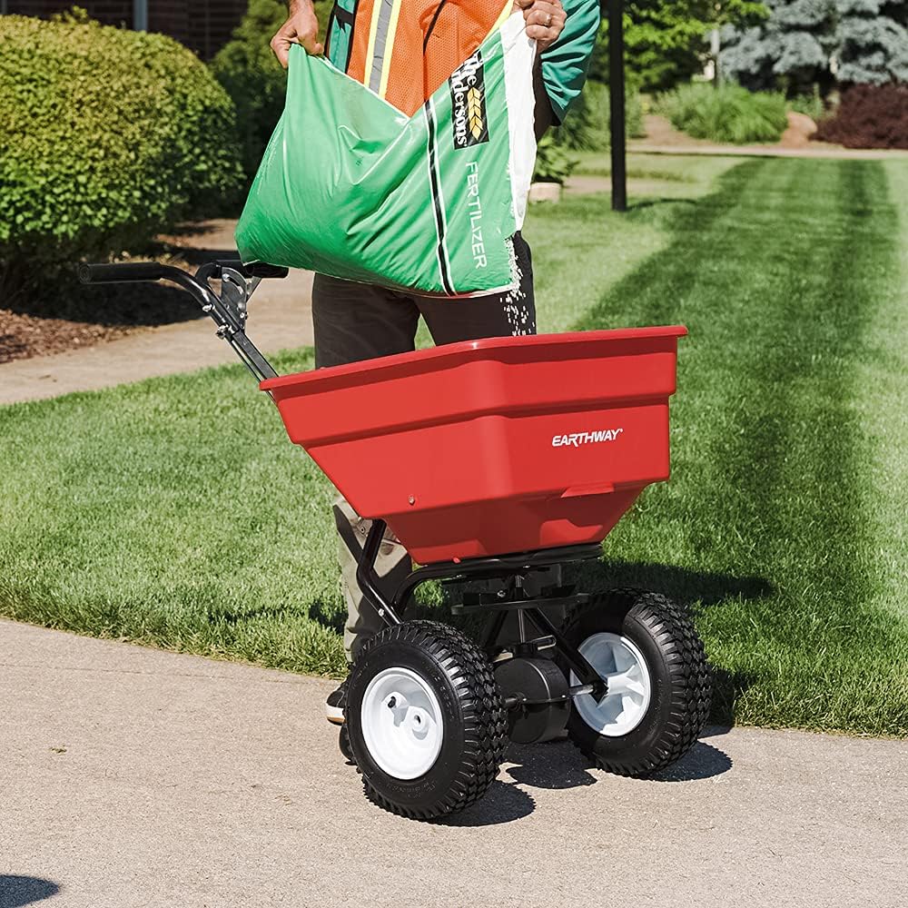 EarthWay 2170 Commercial 100 LB Broadcast Fertilizer Spreader. Red, Heavy-Duty Walk-Behind Push Garden Seeder with Adjustable Drop Rate and Driving Handle. Large 13 inch Pneumatic Stud Tires-
